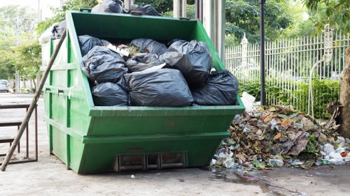 Electric van parked by a transfer station handling materials from Canary Wharf clearances